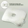 Beauty salon single hole ear pillow in grey on a treatment bed.