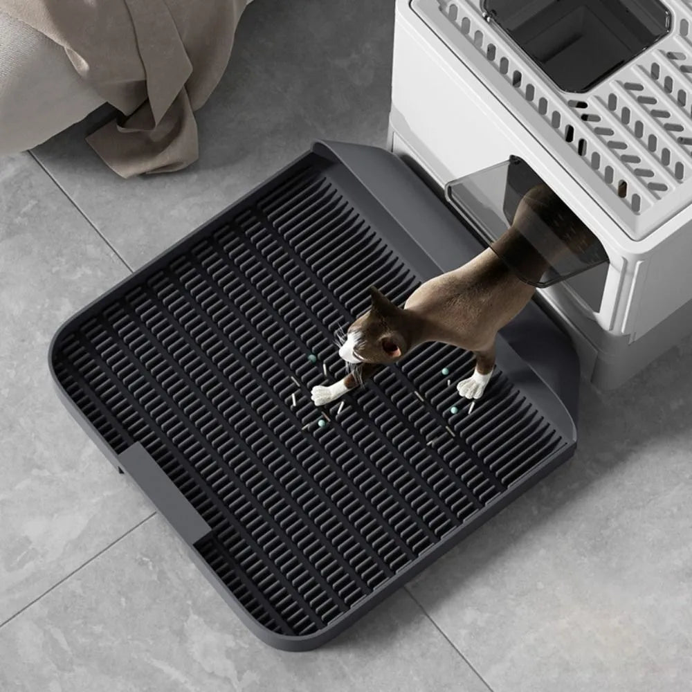 Black cat litter pedal with slanted design and textured grooves for litter containment