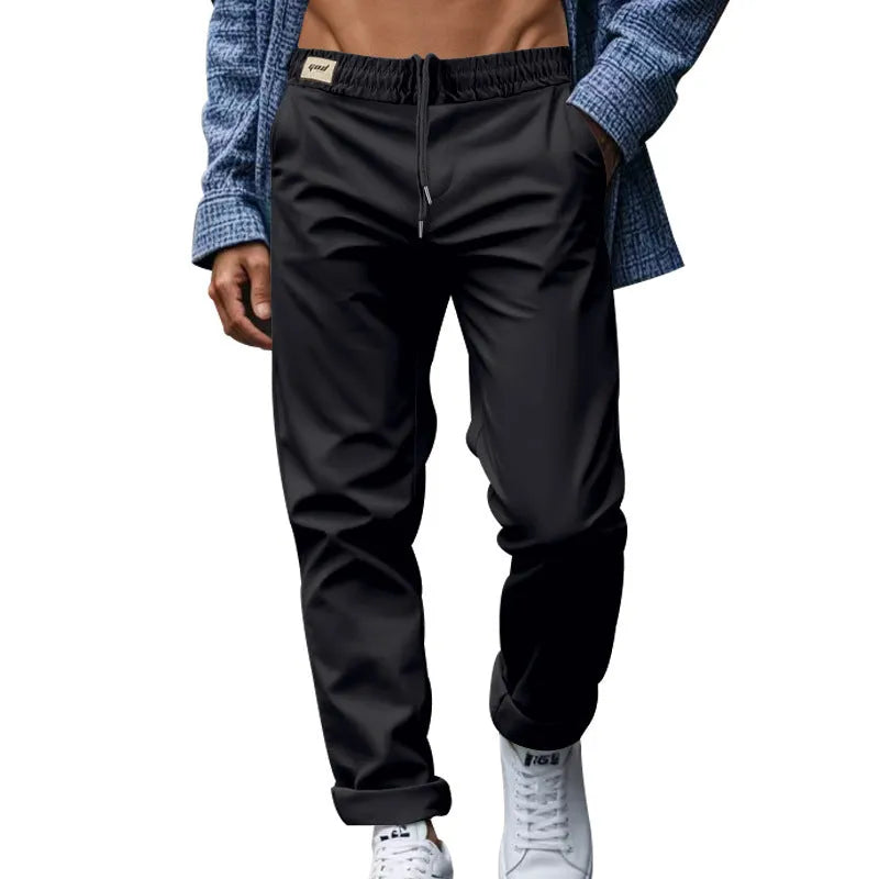 Men's loose fit drawstring trousers in solid colour Beige, side view showing straight leg and mid-waist drawstring closure.