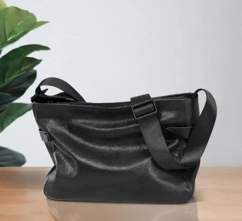 Men's black genuine leather and cowhide crossbody messenger bag with waterproof function and patchwork detail.