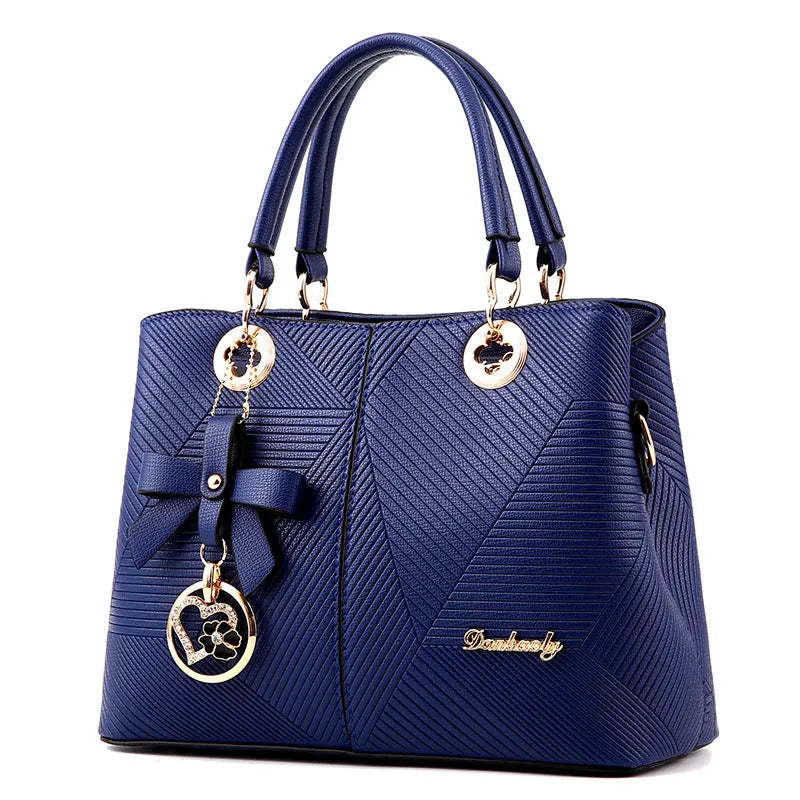 Retro-style handbag in black with a zip top and a single shoulder strap, shown with a phone and wallet inside.
