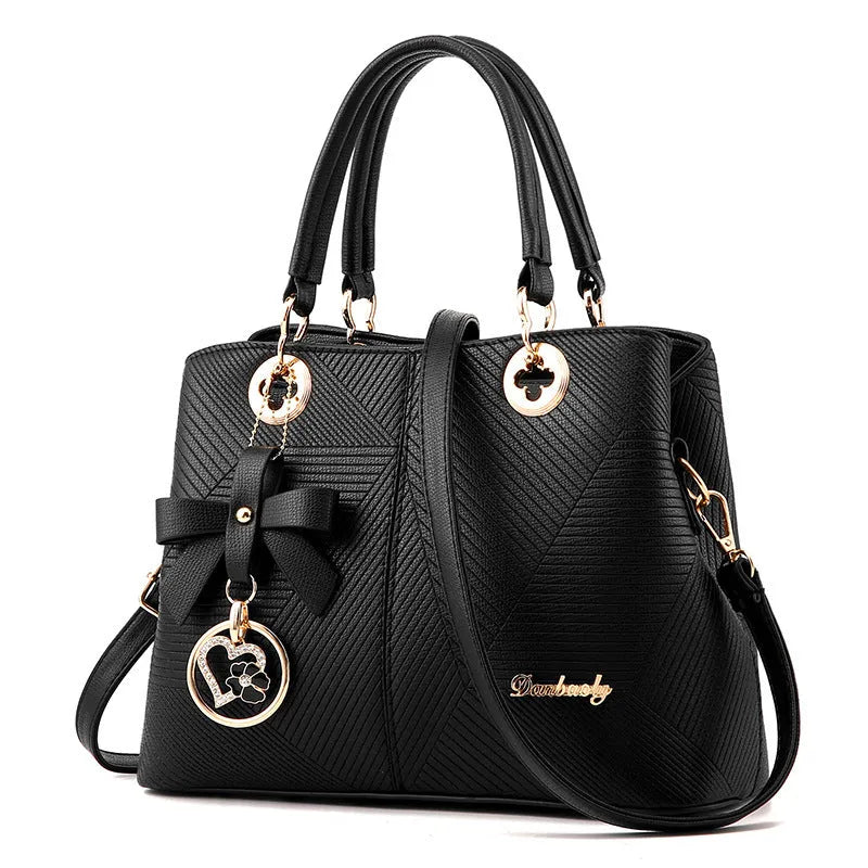 Retro-style handbag in black with a zip top and a single shoulder strap, shown with a phone and wallet inside.