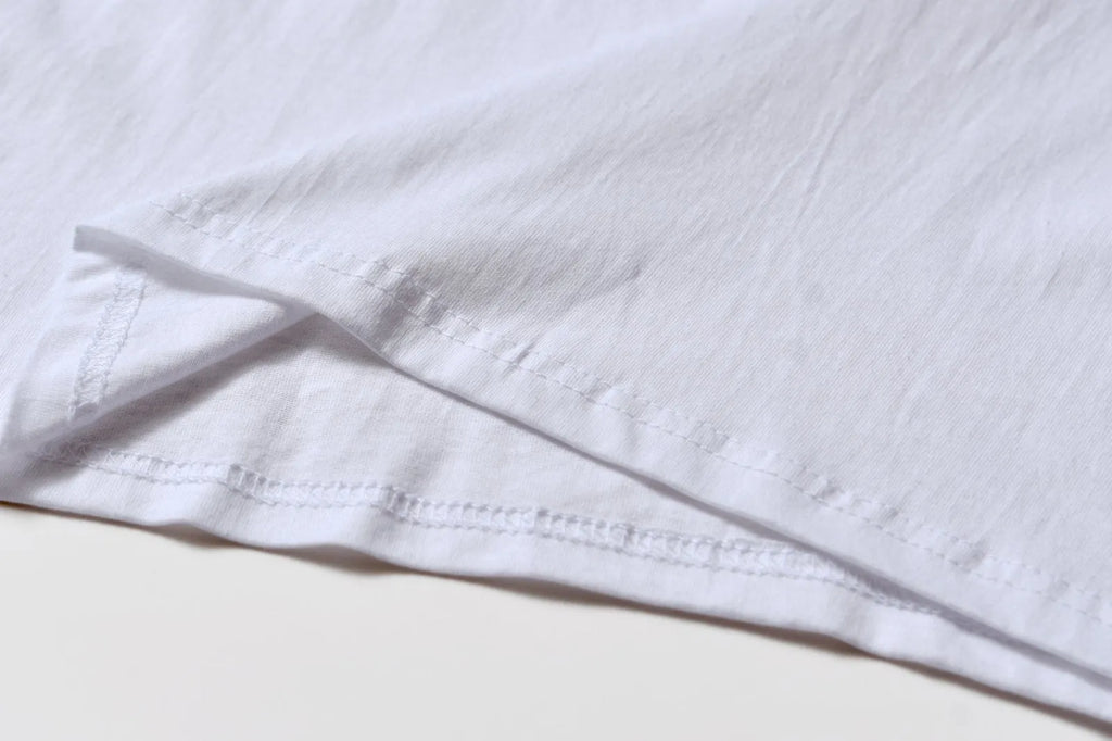 White patterned cotton pullover top with short sleeves on a hanger