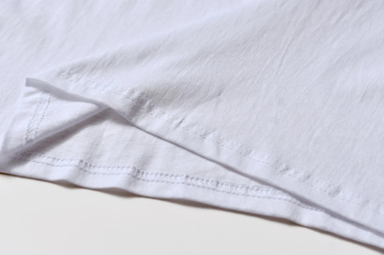 White patterned cotton pullover top with short sleeves on a hanger