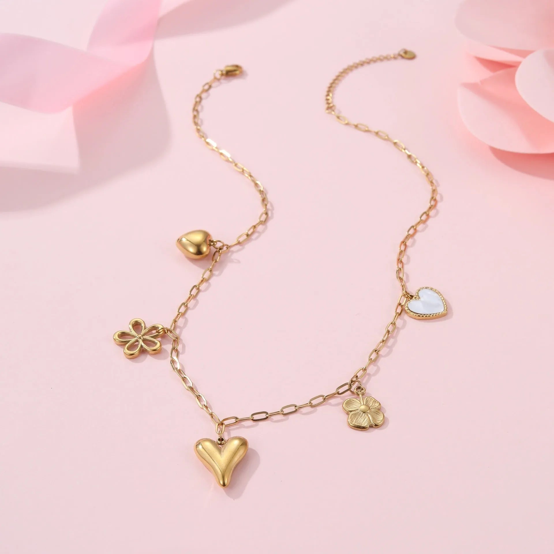 Stainless steel pendant necklace with 18K gold electroplating, showing heart and ribbon sun style options on an adjustable chain.