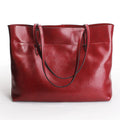 Brown waxed cowhide crossbody handbag showing two main compartments and an internal phone pocket.