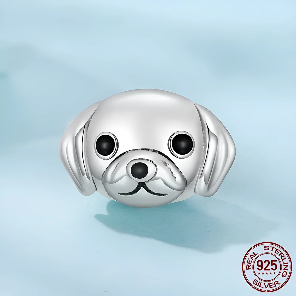 Close up of a single S925 sterling silver bead with golden retriever shape in orange dripping oil finish, 0.8cm high by 1.3cm wide, with 0.45cm aperture