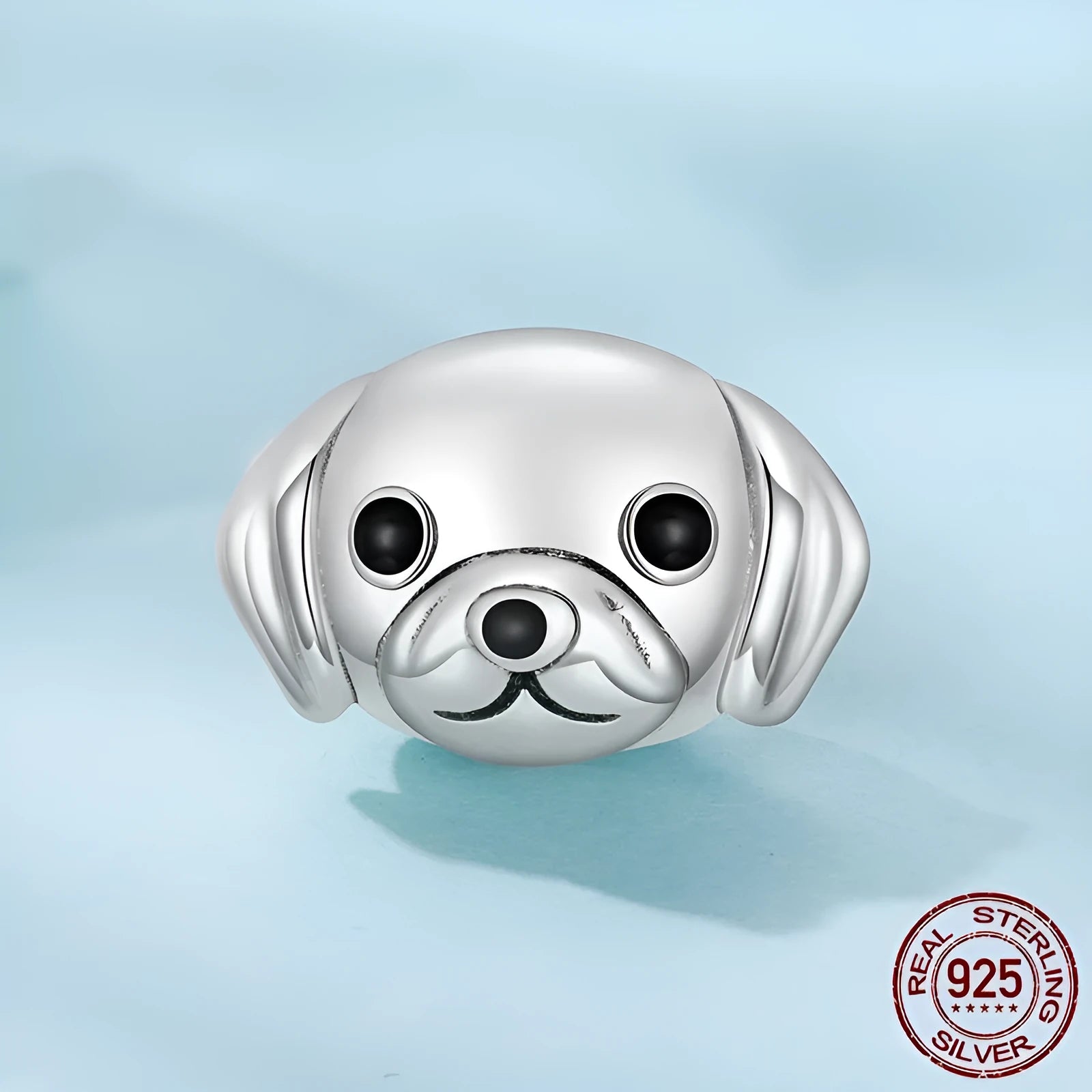 Close up of a single S925 sterling silver bead with golden retriever shape in orange dripping oil finish, 0.8cm high by 1.3cm wide, with 0.45cm aperture