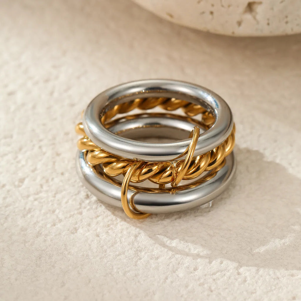 Stacked colour matching stainless steel ring with 18K gold plating on a hand.