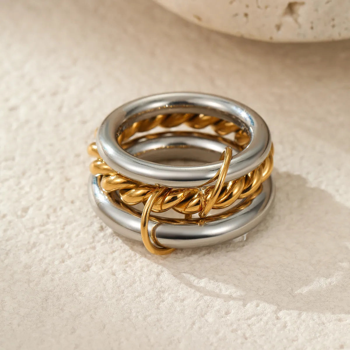 Stacked colour matching stainless steel ring with 18K gold plating on a hand.