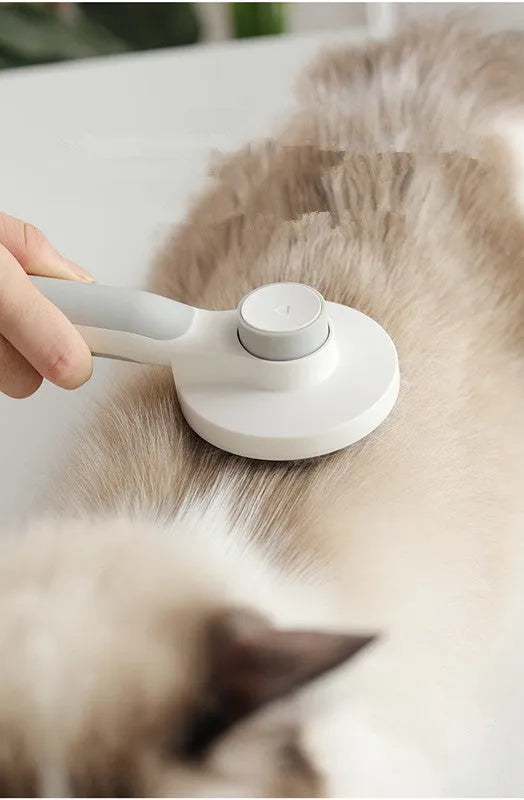 Round handle pet pass-through comb with stainless steel needles and self-cleaning button in pink colour