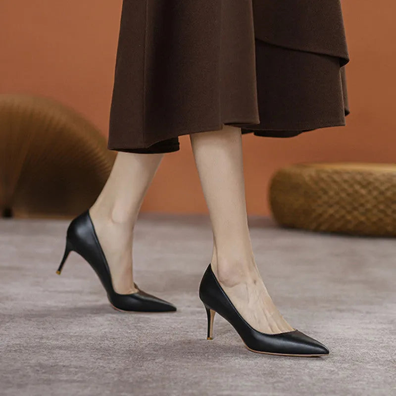 Black pointed-toe stiletto high heel pump shoes for wide feet on a plain background.