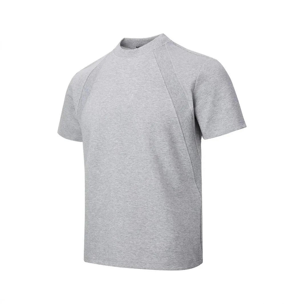 Man wearing a loose-fit grey short-sleeve top with textured air layer stitching detail.