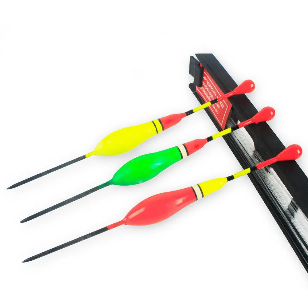 Three vertical fishing floats with wire double hook groups on a grey background