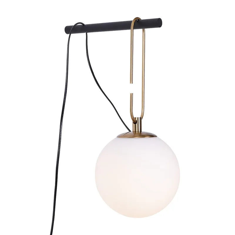 Nordic modern glass wall lamp on a white wall displaying warm white light.