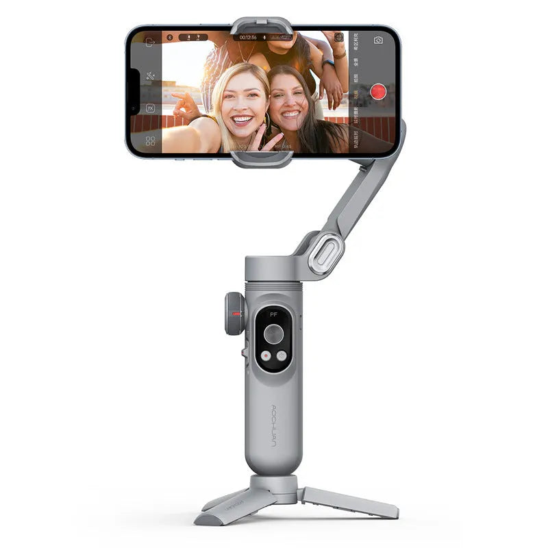 Black mobile phone stabilizer PTZ gimbal with AI tracking module and tripod on a flat surface