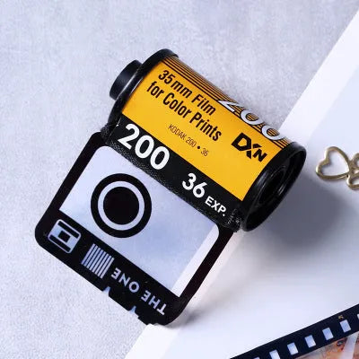 Kodak yellow wooden memory colour film album boxes stacked with a tote bag