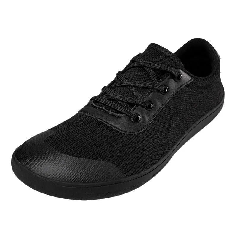 Men's low-top training shoe in a solid colour with a mesh upper and ribbed outsole, shown in a larger size.