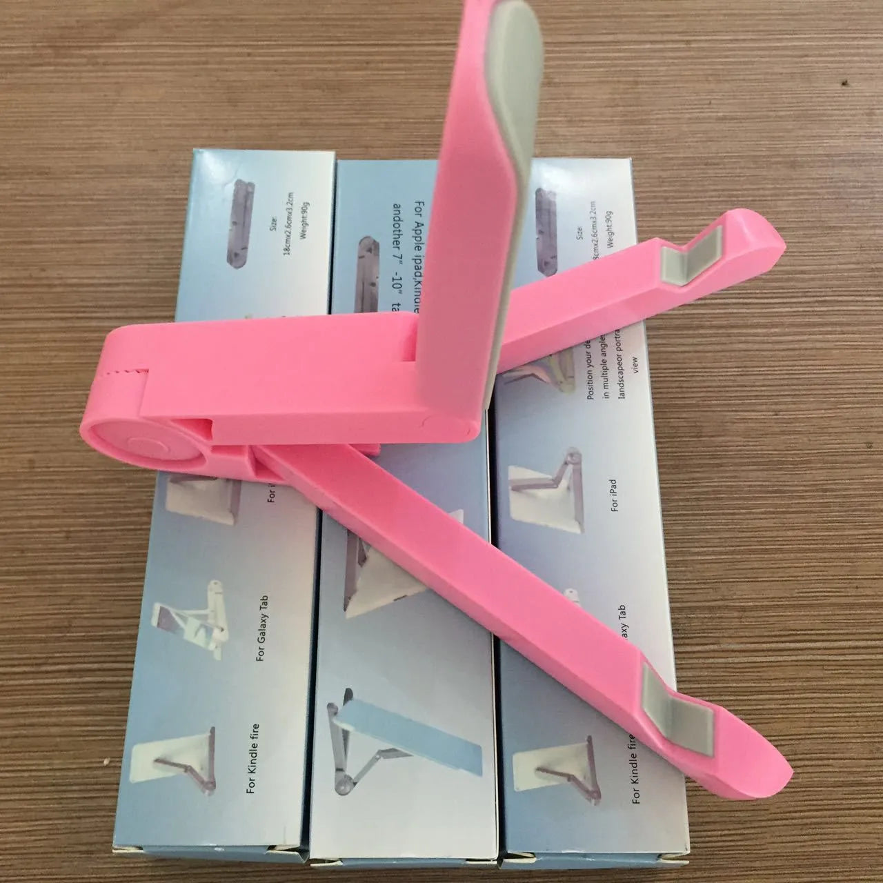 Black foldable tablet holder showing adjustable angles and rubber surface for device protection