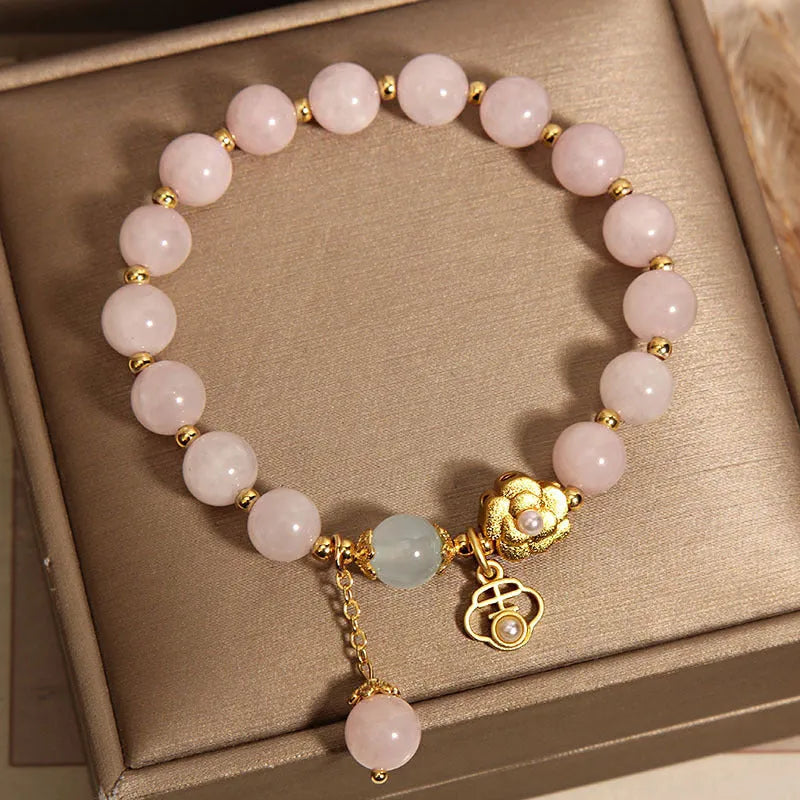 Women's pink crystal bracelet with a refined grace flower design on a wrist.