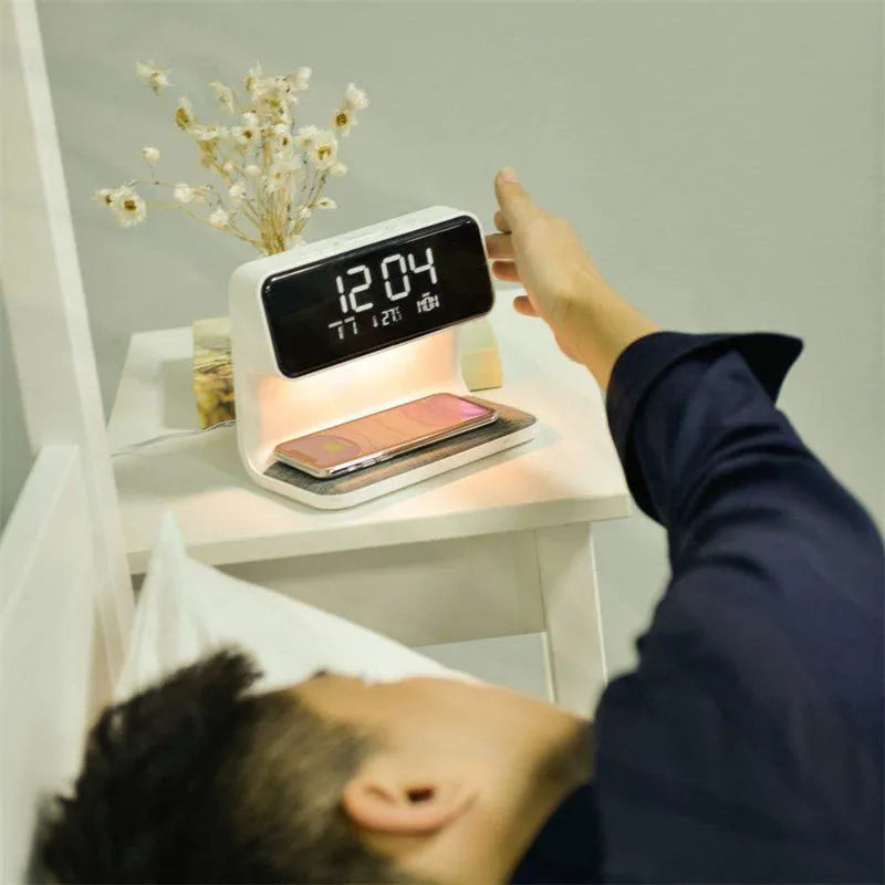 White 3-in-1 bedside lamp with wireless charging pad, LCD clock display, and touch controls.