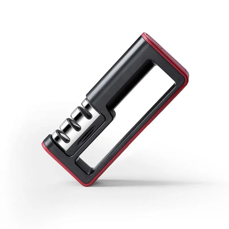 Black and red professional three-stage diamond knife sharpener on a kitchen countertop