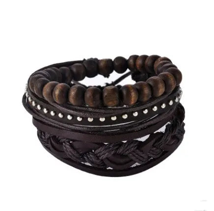 Handmade brown leather wrap bracelet with wooden beads and braided cord on a wrist.