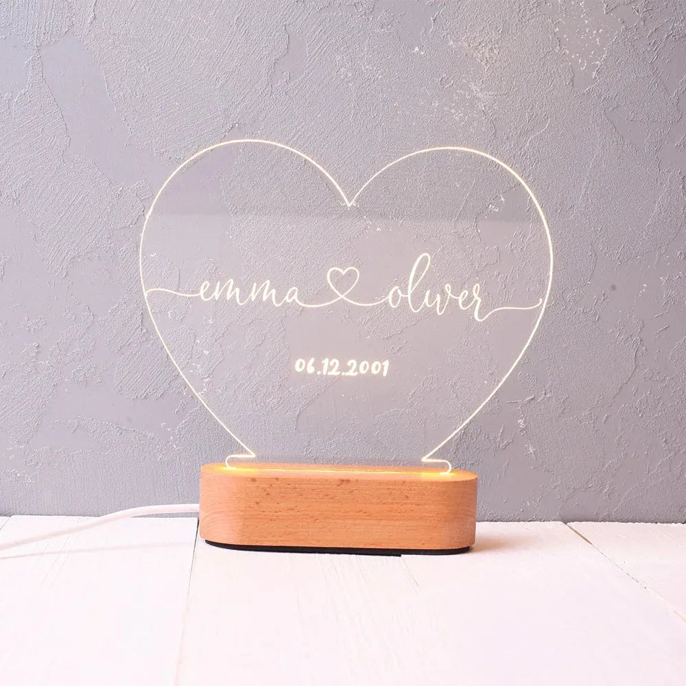 Custom transparent acrylic LED night light personalised with names and date, 20cm by 11.5cm.