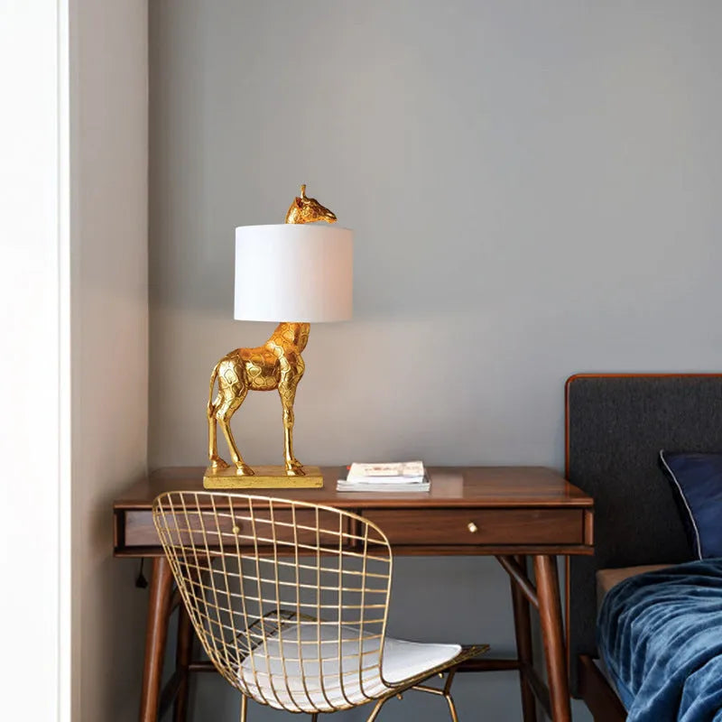 Giraffe table lamp with 66cm height in gold or white finish for bedside and desk lighting