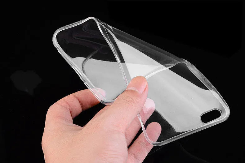 Transparent TPU soft shell protective case for various iPhone models on a table.