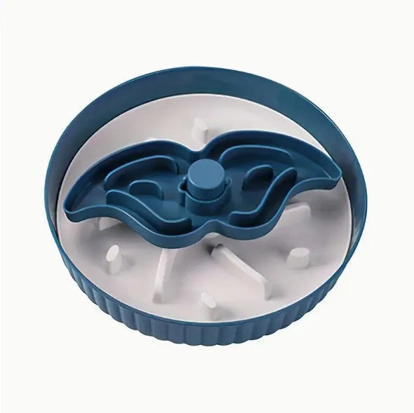 Grey pet bowl with a rotating windmill-pattern silicone licking mat for slow feeding on a kitchen floor.