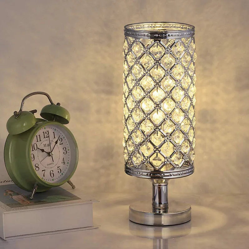 Modern crystal table lamp with hollow-carved design, metal base, gold finish, on bedside table