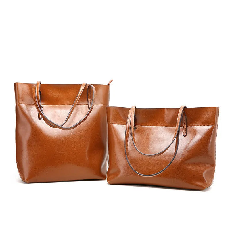Brown waxed cowhide crossbody handbag showing two main compartments and an internal phone pocket.