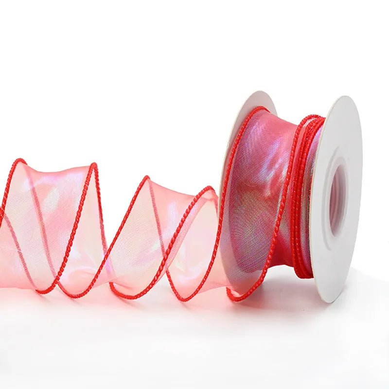 Roll of colourful fishtail yarn wave ribbon in mesh material, showing its textured, wave-like design.
