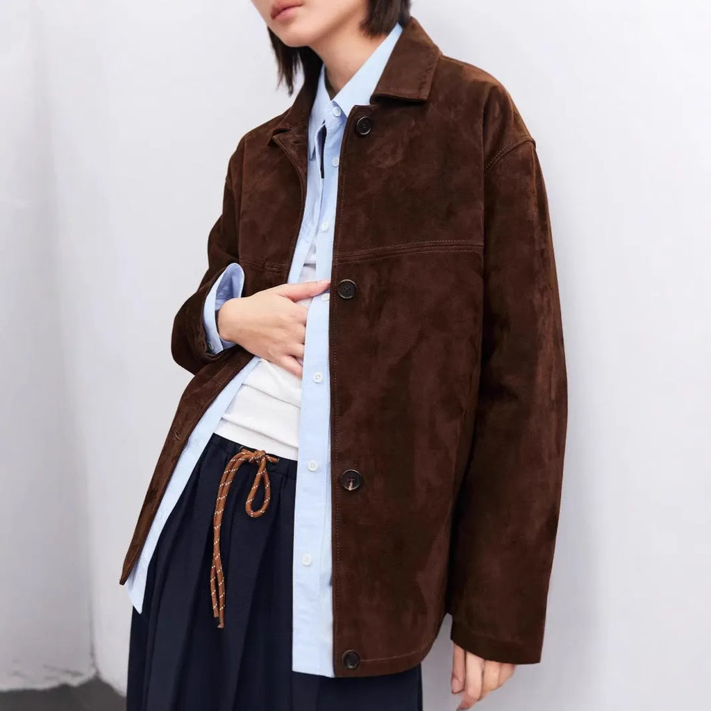 Yellow brown mid-length coat with Peter Pan collar and leather stitching on front.