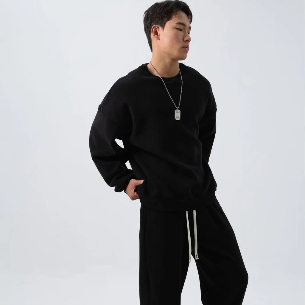 Men's black polar fleece winter sports suit with loose fit long sleeve coat and matching trousers