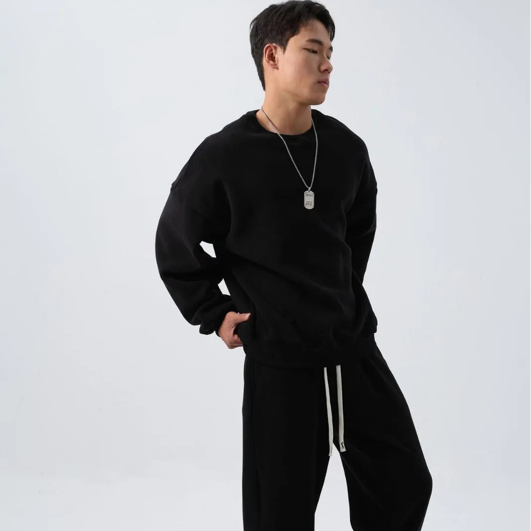 Men's black polar fleece winter sports suit with loose fit long sleeve coat and matching trousers