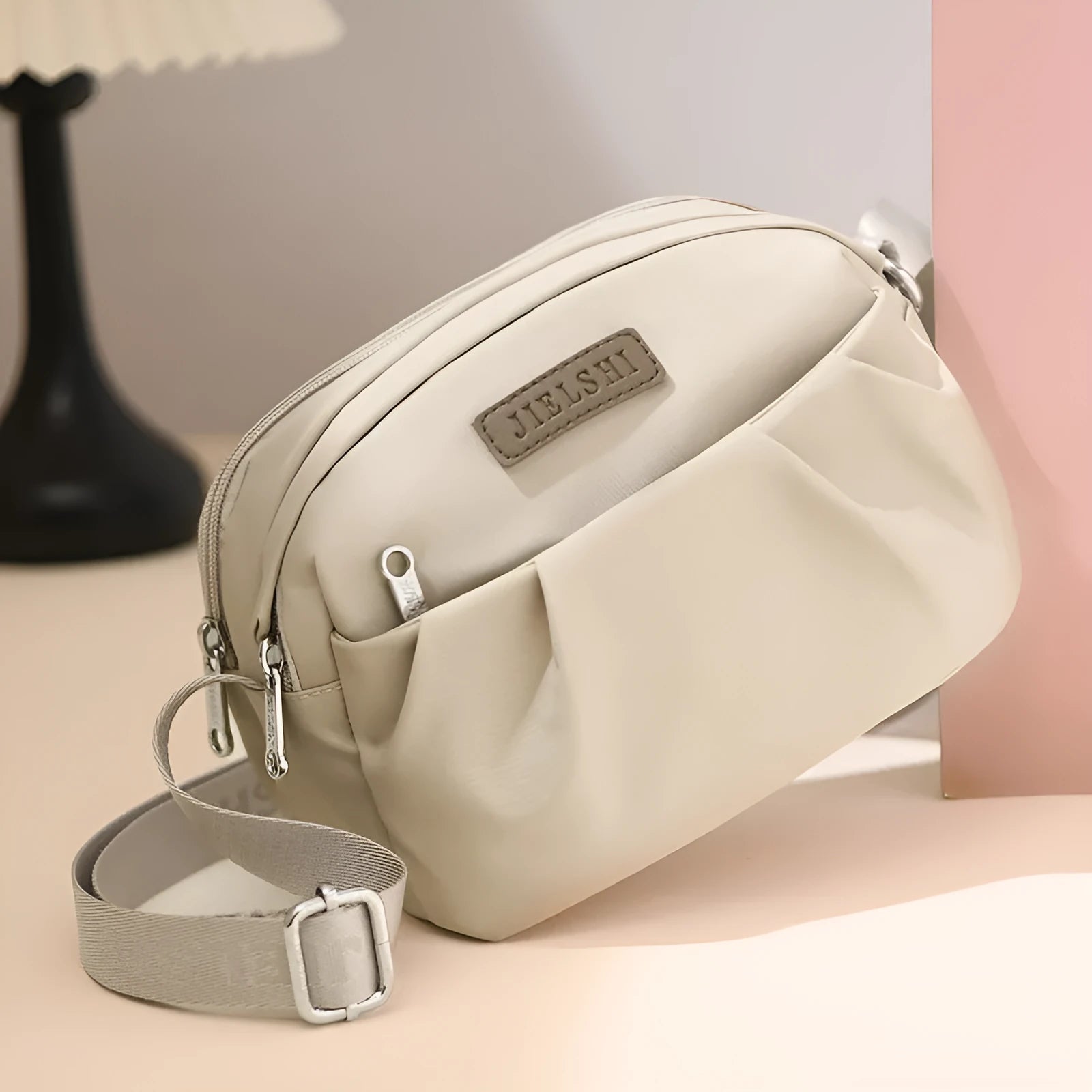 Pleated Oxford cloth horizontal messenger bag in cangling green, showing cross-body strap and external pocket.