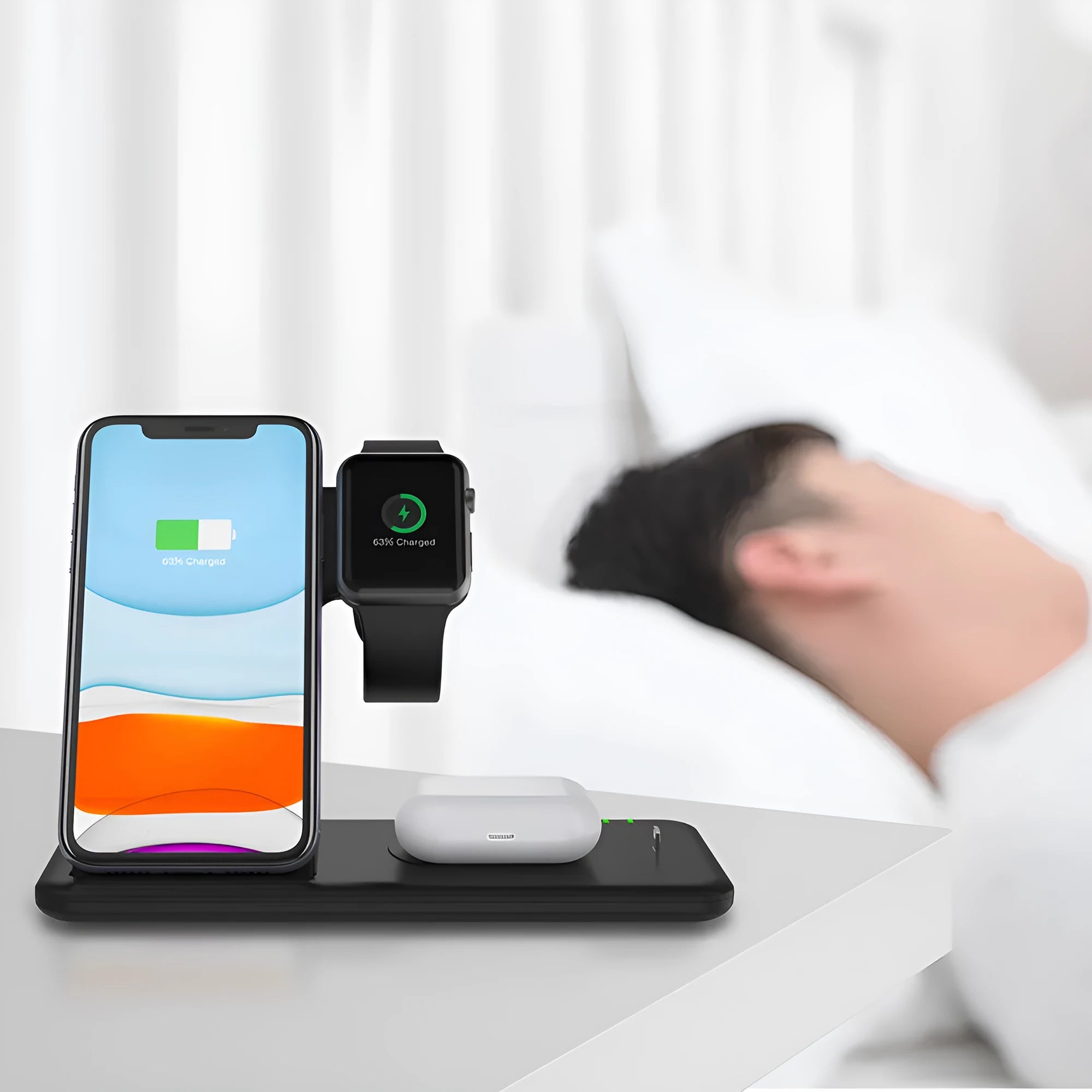 White 15W three-in-one wireless charging stand for mobile phone, smartwatch and headset on a desk.