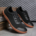 Men's low-top training shoe in a solid colour with a mesh upper and ribbed outsole, shown in a larger size.