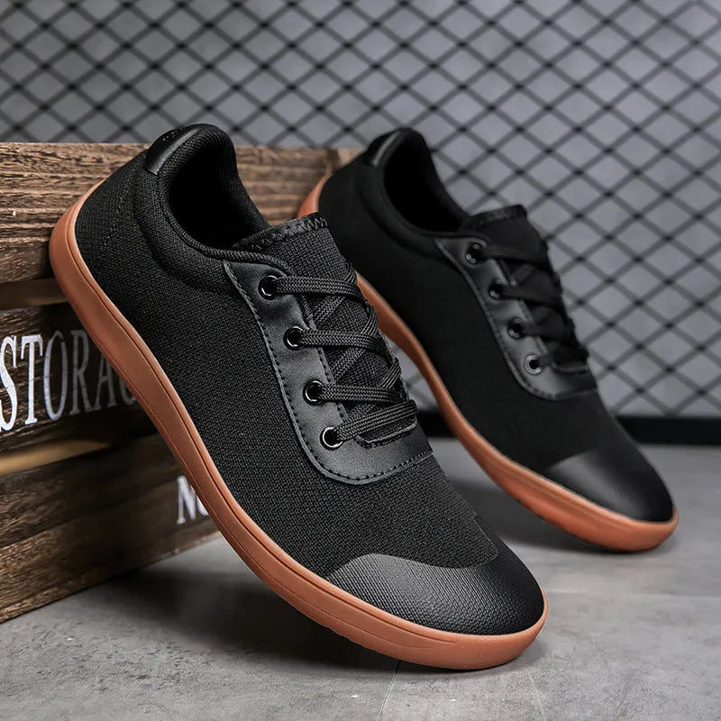 Men's low-top training shoe in a solid colour with a mesh upper and ribbed outsole, shown in a larger size.