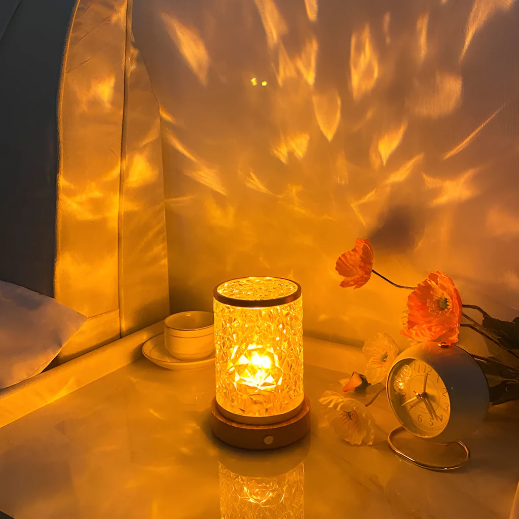 Modern rotating water ripple night light with a wooden base and touch control on a bedside table.