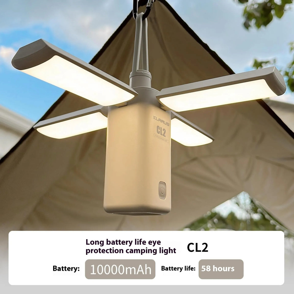 White and green rechargeable LED campsite lamp with charging cable on outdoor picnic table.
