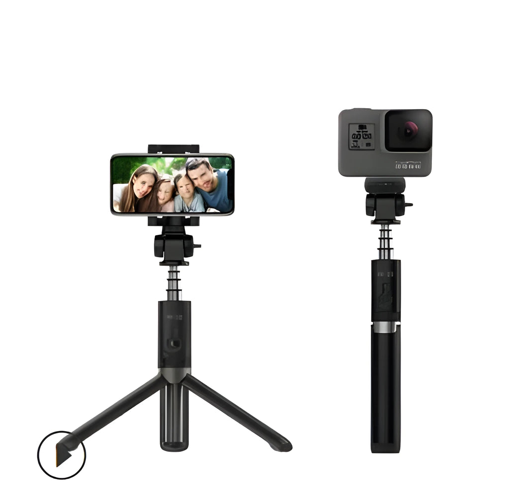 Black Bluetooth selfie stick with tripod base and remote control extended next to smartphone