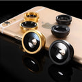 Three smartphone clip-on lenses: fisheye, wide-angle, and macro, in assorted colours on a table