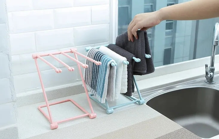 Foldable light grey plastic dishcloth shelf with vertical design mounted on a wall