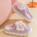 Light blue women's plush slippers with an animal pattern on the round toe holder and a thick fleece lining.