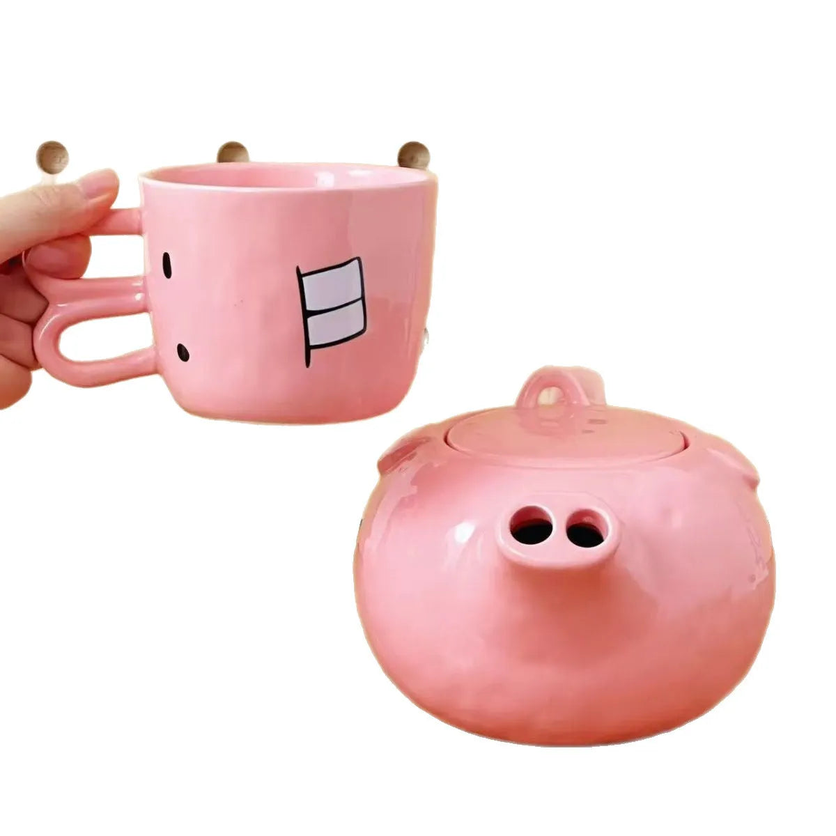 Creative ceramic piggy teapot nose mug set with pink pig pot and rabbit cup on a table