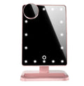 Pink and white LED makeup mirror with a ring of lights, a 10X magnifying panel, and a Bluetooth speaker on a dressing table.