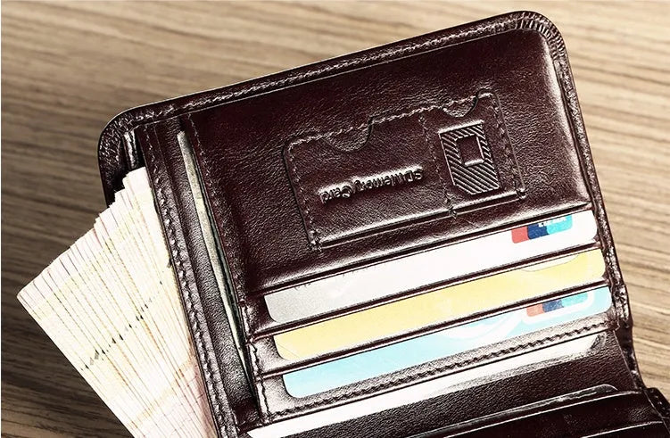 Men's black genuine leather bi-fold wallet open, showing eight card slots, a note compartment, and a zipped coin pouch.